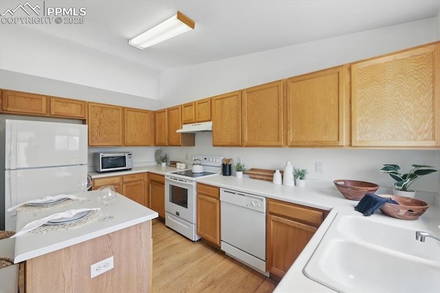 5012 Chaise Dr, Colorado Springs, CO 80923 - kitchen featuring white appliances, under cabinet range hood, lofted ceiling, light countertops, and light wood-style floors