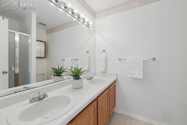 5012 Chaise Dr, Colorado Springs, CO 80923 - full bathroom featuring a stall shower and double vanity