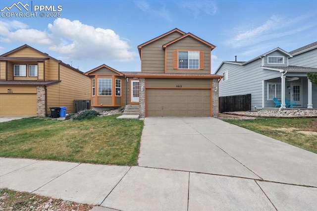 5012 Chaise Dr, Colorado Springs, CO 80923 - traditional home with brick siding, an attached garage, and driveway