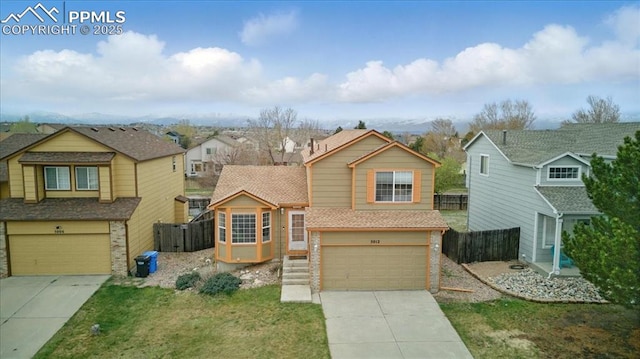 5012 Chaise Dr, Colorado Springs, CO 80923 - view of front of house featuring an attached garage, concrete driveway, brick siding, and a residential view