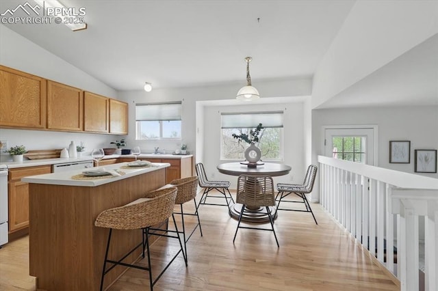 5012 Chaise Dr, Colorado Springs, CO 80923 - kitchen featuring light countertops, light wood-style flooring, a breakfast bar, a sink, and hanging light fixtures