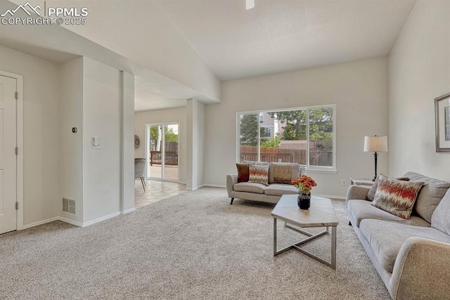 carpeted living area featuring visible vents and baseboards