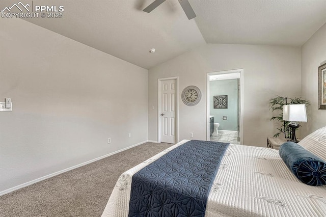 carpeted bedroom with connected bathroom, a ceiling fan, vaulted ceiling, and baseboards