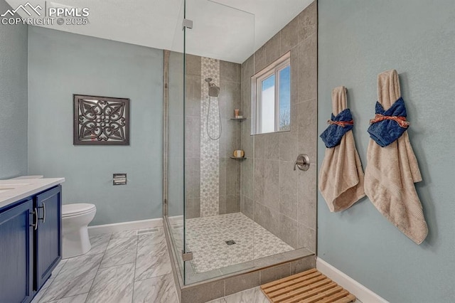 full bath featuring a shower stall, baseboards, toilet, vanity, and marble finish floor