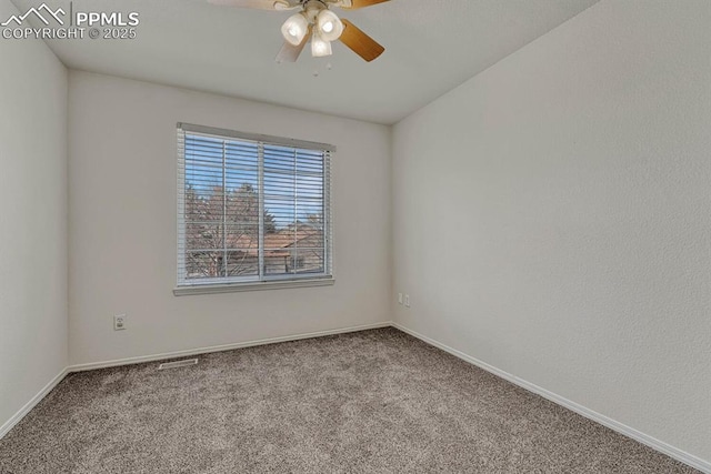 empty room with a ceiling fan, baseboards, and carpet floors