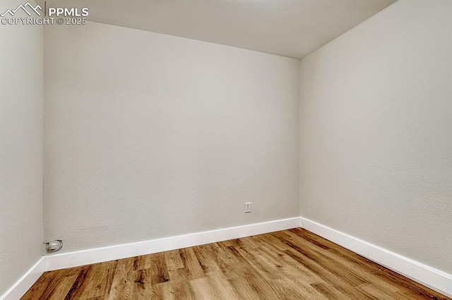 empty room with wood finished floors and baseboards