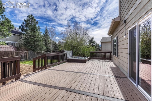 wooden deck with a fenced backyard