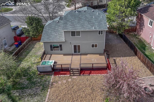 rear view of house with a deck, a shingled roof, and a fenced backyard