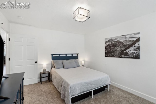 carpeted bedroom featuring baseboards