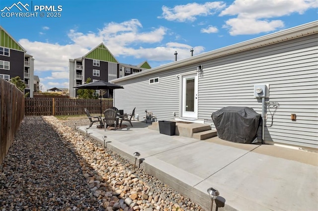 view of patio with a fenced backyard and a grill