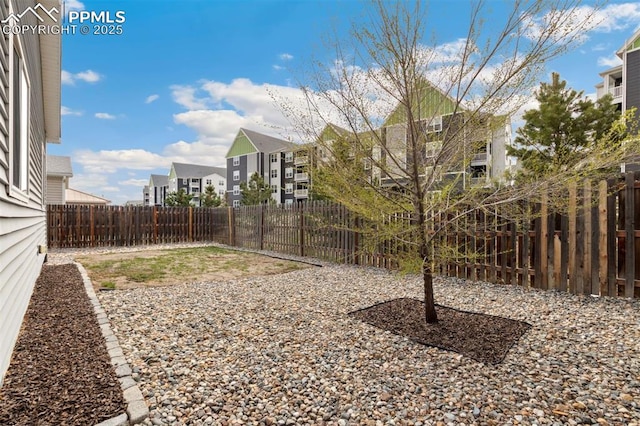 view of yard with a residential view and a fenced backyard