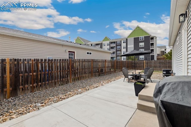 view of patio / terrace with area for grilling and a fenced backyard