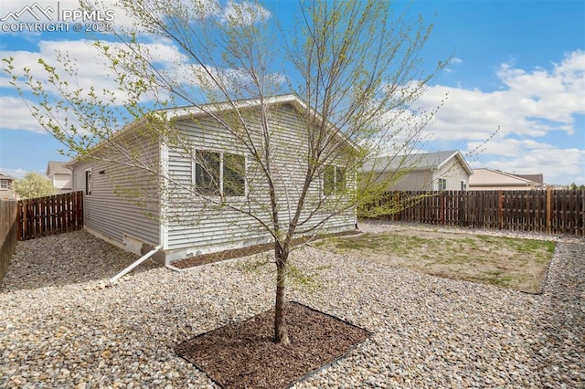 view of side of property with a fenced backyard