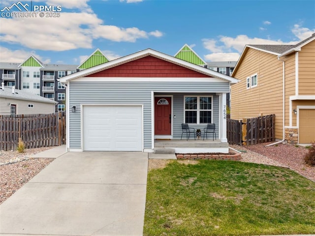 view of front of property featuring a garage, fence, covered porch, a front yard, and concrete driveway