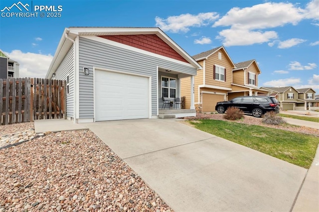 view of front of home with a garage, fence, and driveway