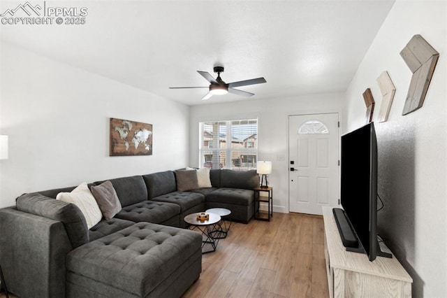 living area featuring a ceiling fan and light wood-style flooring