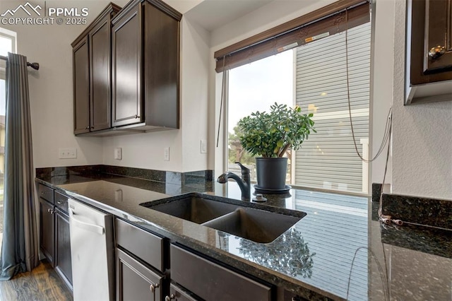 6775 Hazel Branch Ct, Colorado Springs, CO 80927 - kitchen with dark stone countertops, a sink, dark brown cabinets, dark wood-style flooring, and dishwasher