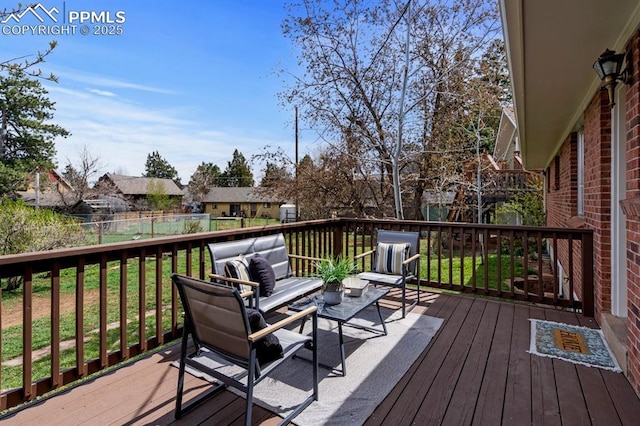 25 High St, Palmer Lake, CO 80133 - wooden terrace with outdoor lounge area, fence, and a yard