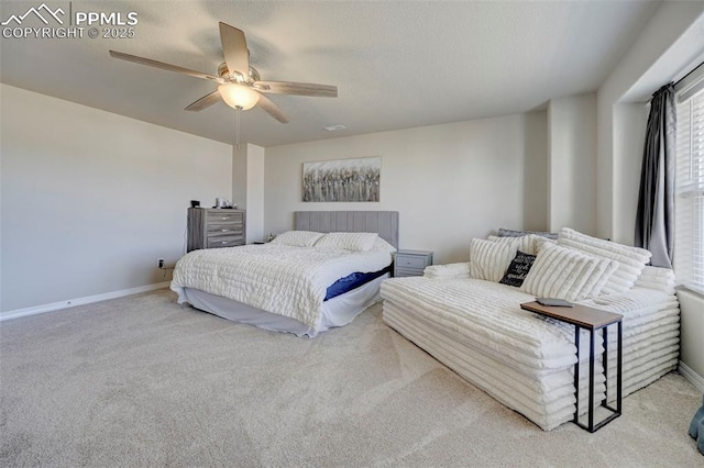 carpeted bedroom with baseboards and a ceiling fan