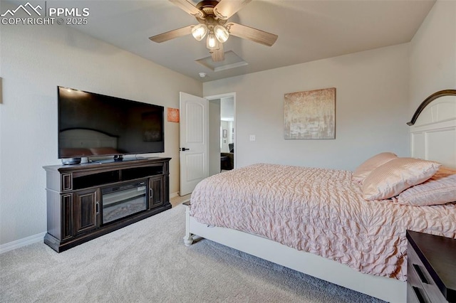 carpeted bedroom featuring baseboards and a ceiling fan