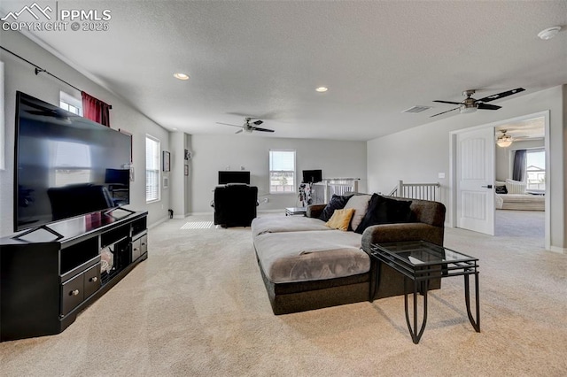 living area featuring light colored carpet, recessed lighting, baseboards, and ceiling fan