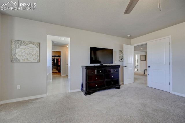 unfurnished bedroom featuring baseboards, carpet, and a ceiling fan