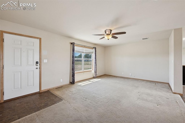 entryway featuring carpet, visible vents, a ceiling fan, and baseboards