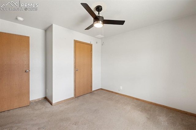 unfurnished bedroom with a ceiling fan, light colored carpet, and baseboards