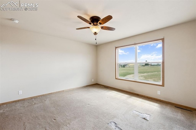 empty room featuring visible vents, a ceiling fan, carpet flooring, and baseboards