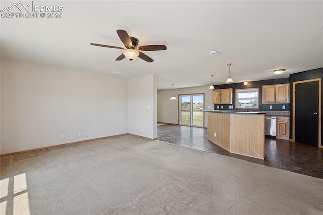 kitchen featuring stainless steel dishwasher, dark countertops, ceiling fan, baseboards, and open floor plan