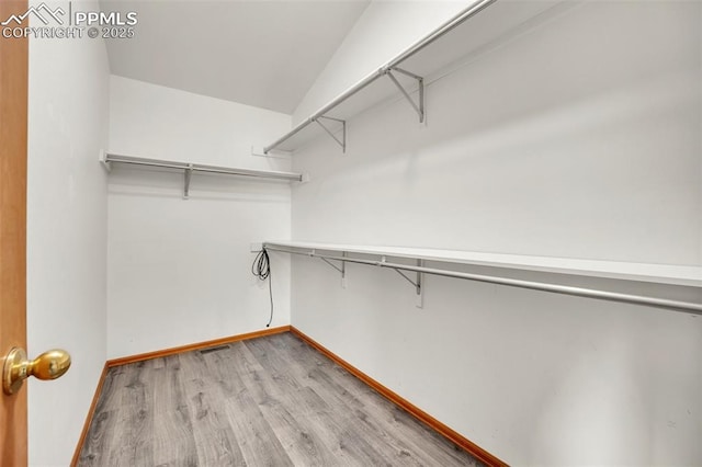 spacious closet with wood finished floors