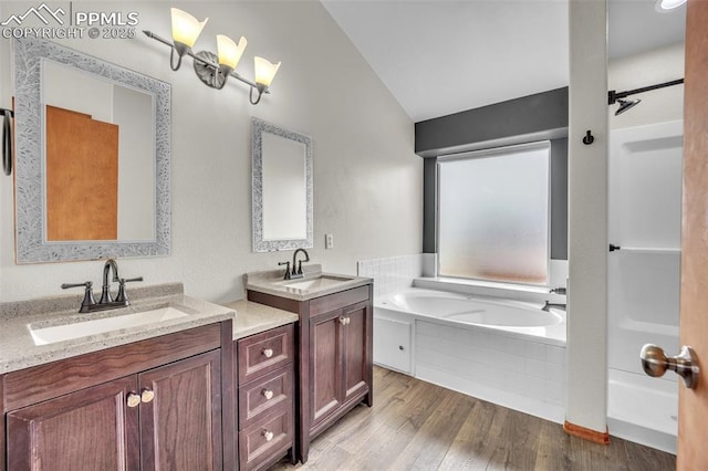 full bath with wood finished floors, lofted ceiling, a bath, two vanities, and a shower