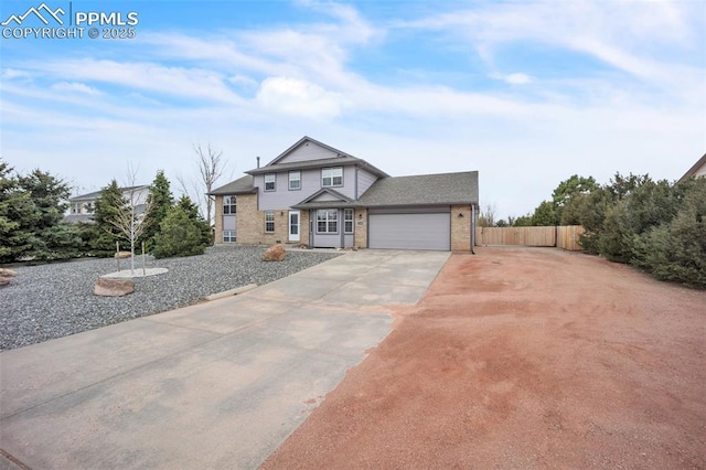 view of front of property featuring fence, concrete driveway, brick siding, and a garage