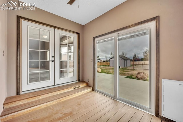 doorway to outside featuring light wood-style flooring, ceiling fan, and french doors