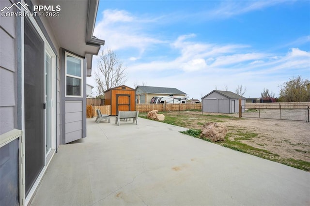 view of patio / terrace with a shed, an outdoor structure, and a fenced backyard