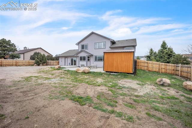 back of house with a patio, a fenced backyard, an outdoor structure, and a storage shed