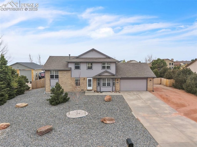 view of front facade with fence, brick siding, a garage, driveway, and roof with shingles