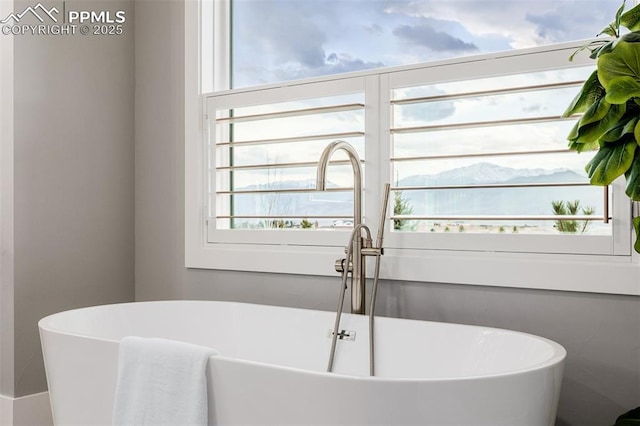 full bath with a freestanding bath and a sink