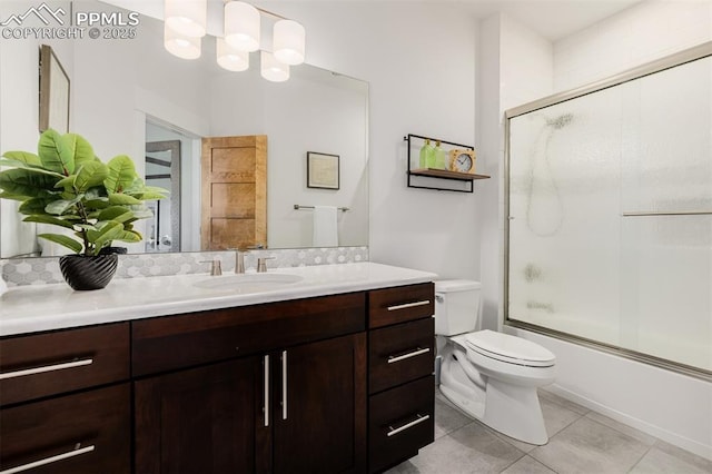 full bath featuring toilet, tile patterned flooring, enclosed tub / shower combo, and vanity