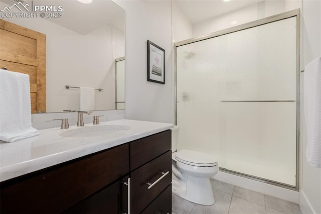 bathroom with toilet, tile patterned flooring, a shower stall, and vanity