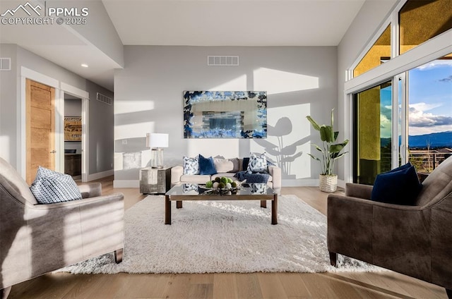living area with visible vents, wood finished floors, and recessed lighting