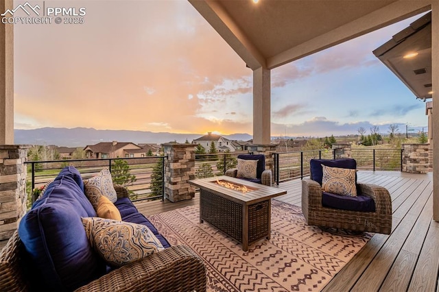 deck at dusk featuring visible vents and a fire pit