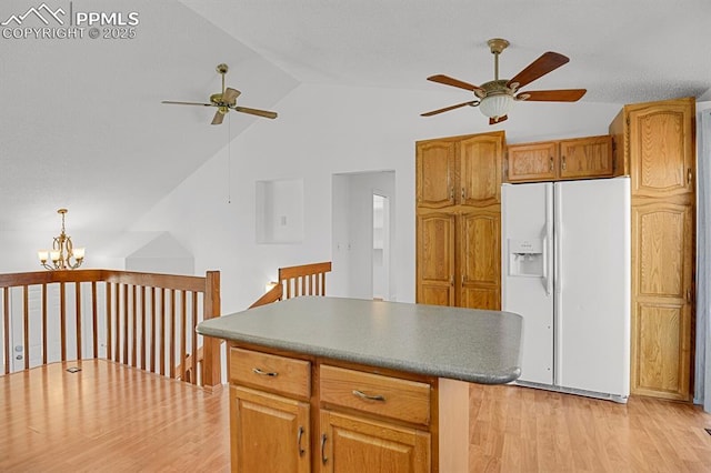 3925 Zurich Dr, Colorado Springs, CO 80920 - kitchen with white fridge with ice dispenser, a ceiling fan, lofted ceiling, light wood-style flooring, and a chandelier