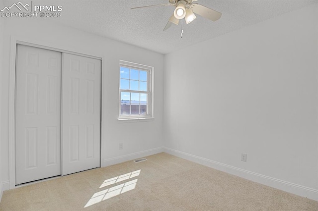 3925 Zurich Dr, Colorado Springs, CO 80920 - unfurnished bedroom featuring carpet, a closet, baseboards, a textured ceiling, and ceiling fan