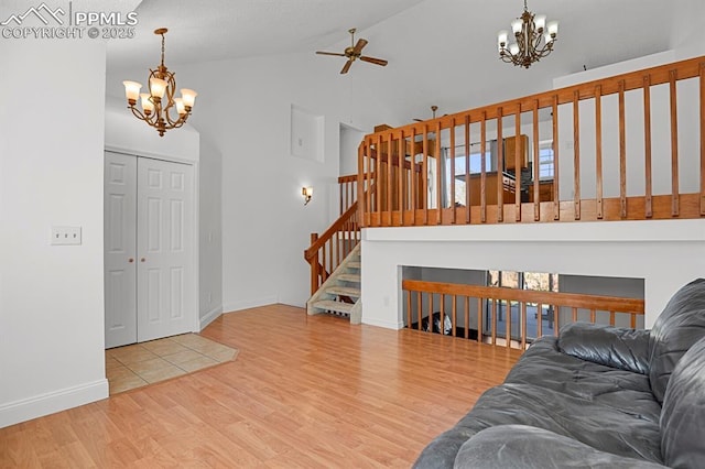 3925 Zurich Dr, Colorado Springs, CO 80920 - living room with a chandelier, a ceiling fan, wood finished floors, high vaulted ceiling, and baseboards