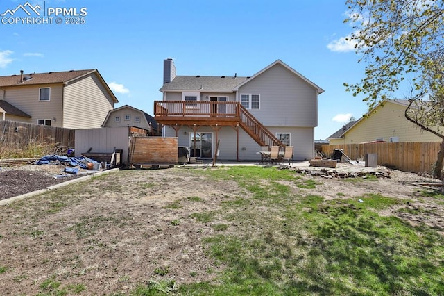 3925 Zurich Dr, Colorado Springs, CO 80920 - rear view of property featuring stairs, a deck, a patio, a fenced backyard, and a fire pit