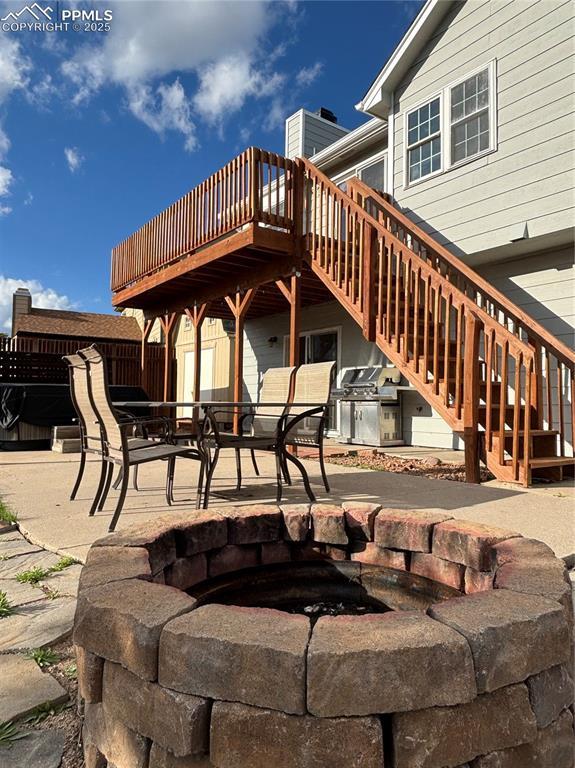 3925 Zurich Dr, Colorado Springs, CO 80920 - back of property featuring stairway, a patio, and a deck
