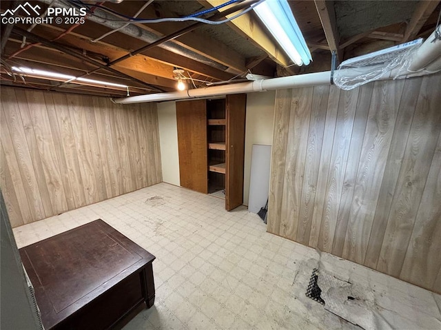 3925 Zurich Dr, Colorado Springs, CO 80920 - unfinished basement featuring wooden walls and tile patterned floors
