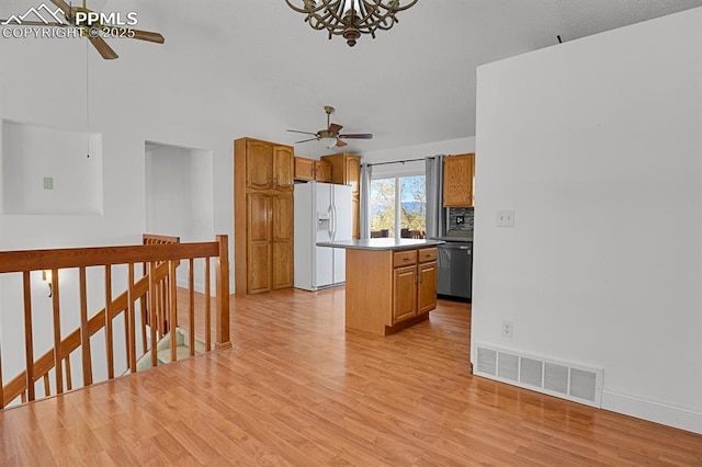 3925 Zurich Dr, Colorado Springs, CO 80920 - kitchen with white fridge with ice dispenser, ceiling fan, dishwasher, and a center island
