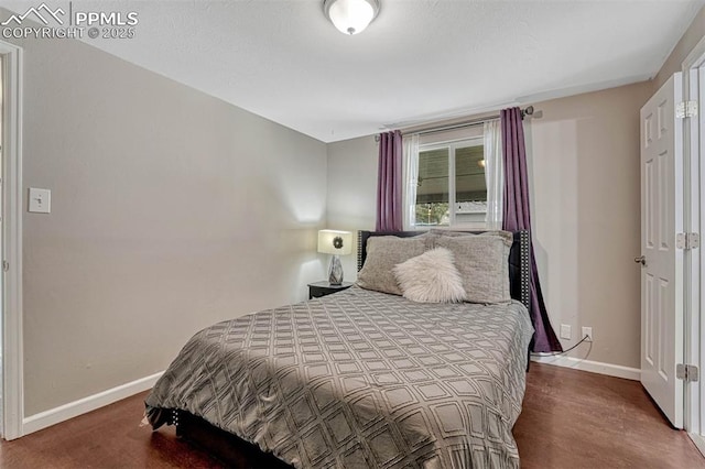 5477 E Asbury Ave, Denver, CO 80222 - bedroom featuring baseboards and wood finished floors